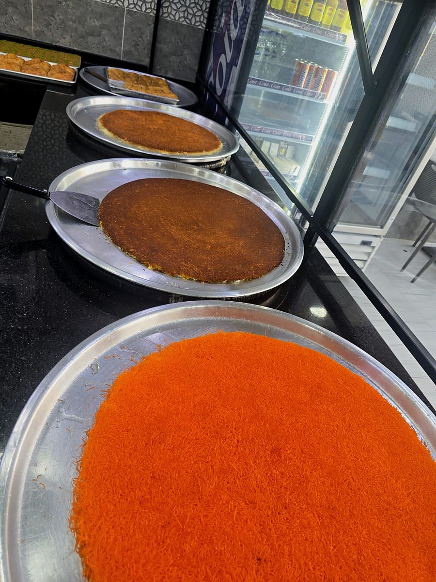 Orange kunafa trays on the Al Qusais counter